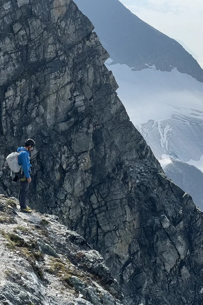 Philip Setter alone on a mountain ridge above a glacier